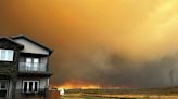 Parts of Canadian city in oil sands region evacuated as wildfire draws near