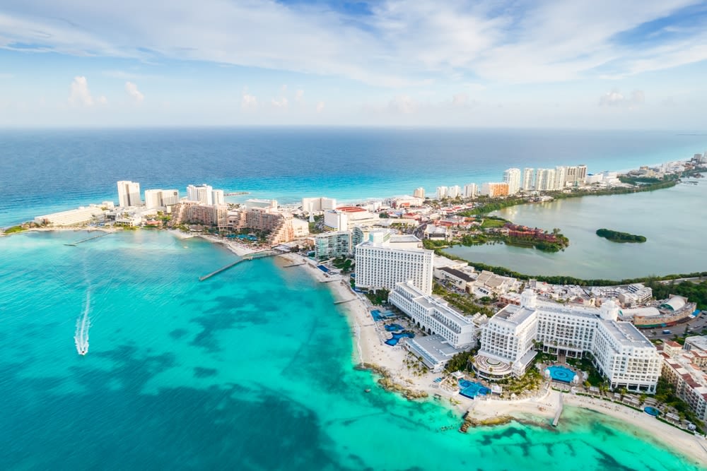 Gunmen on a jet ski open fire at a beach in Cancun, killing a 12-year-old boy