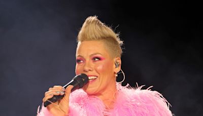 Pink vows to 'kick a**' as she returns to the stage following brief illness