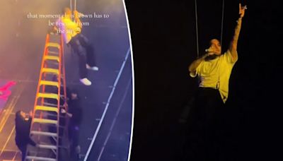 Chris Brown gets stuck dangling in the air during concert, rescued by ladder