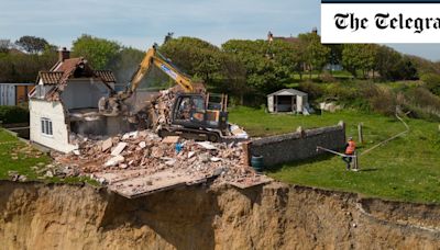 Pictured: Farmhouse left hanging over cliff edge demolished to stop it from plunging to beach below