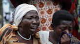 Ugandan border town buries victims of rebel massacre that left 42 dead, mostly students