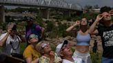 PHOTOS: Clouds break just in time for many in Texas to view eclipse