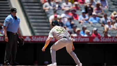 Oakland's Kyle McCann called out after missing home plate and then making contact with a teammate