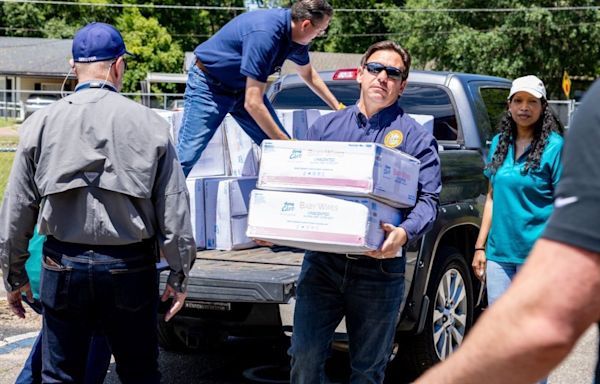 Florida Gov. DeSantis visits Tallahassee school to help distribute supplies after storm