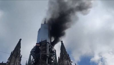 Famous French cathedral erupts into flames as onlookers share videos of smoke billowing into the sky