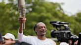Watch: Snoop Dogg Dances the Olympic Torch Through Paris Suburb Ahead of Opening Ceremony
