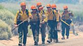 Crew members of the Little Tujunga Hot Shots hike to positions along Hard Luck Road to observe a burn-out operation near Hungry Valley Road as the Post fire continues...
