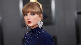 Singer Taylor Swift steps out in a glittery midnight blue dress for the Grammys