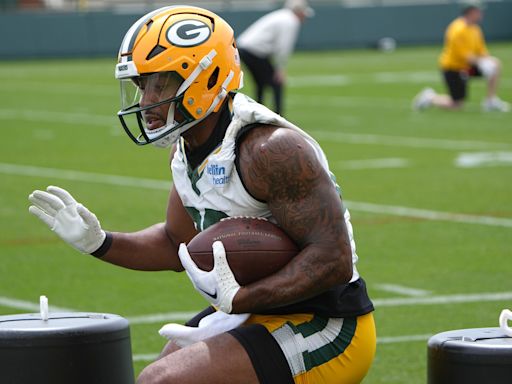 AJ Dillon runs the stairs at an empty Lambeau Field and teammate Keisean Nixon tells him to go on vacation