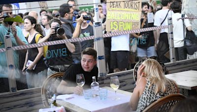 Barcelona residents are so fed up with tourism they’re squirting visitors with water guns as they try to enjoy their meals