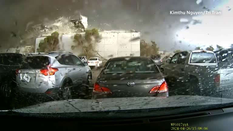 Dashcam captures a tornado destroying a Nebraska building