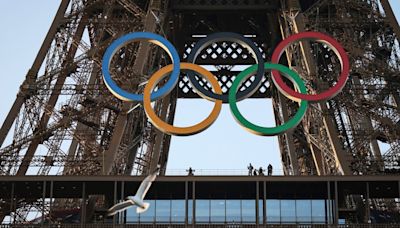 Paris Olympics organizers unveil a display of the five Olympic rings mounted on the Eiffel Tower