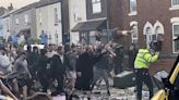 Police clash with an unruly crowd gathered near the site of UK stabbing attack that killed 3 girls