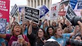 'I cannot believe we are here again': Protesters take to streets across US after Supreme Court overturns Roe