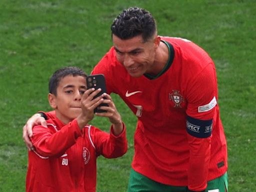 Cristiano Ronaldo poses for selfie with Euro 2024 pitch invader