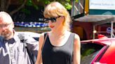 Taylor Swift Channels Her ‘1989’ Era in a Belted Black Maxi Dress, Wayfarers, and Red Lipstick