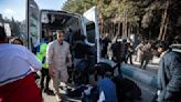 Iran says at least 84 were killed in blasts at a ceremony honoring slain general