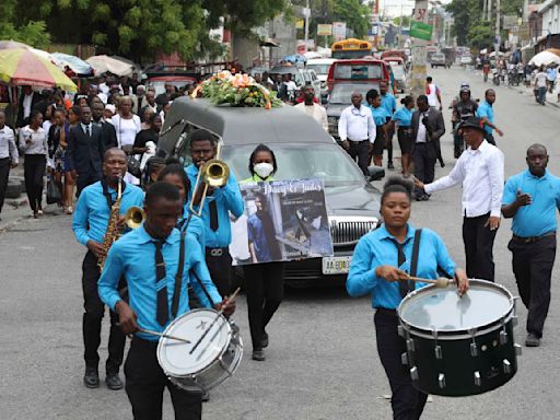 Hundreds mourn gang killings of a Haitian mission director and a young American couple