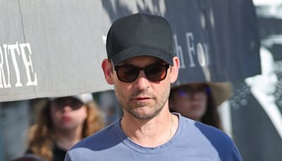 Tobey Maguire, 49, chats up a young brunette woman on French vacation
