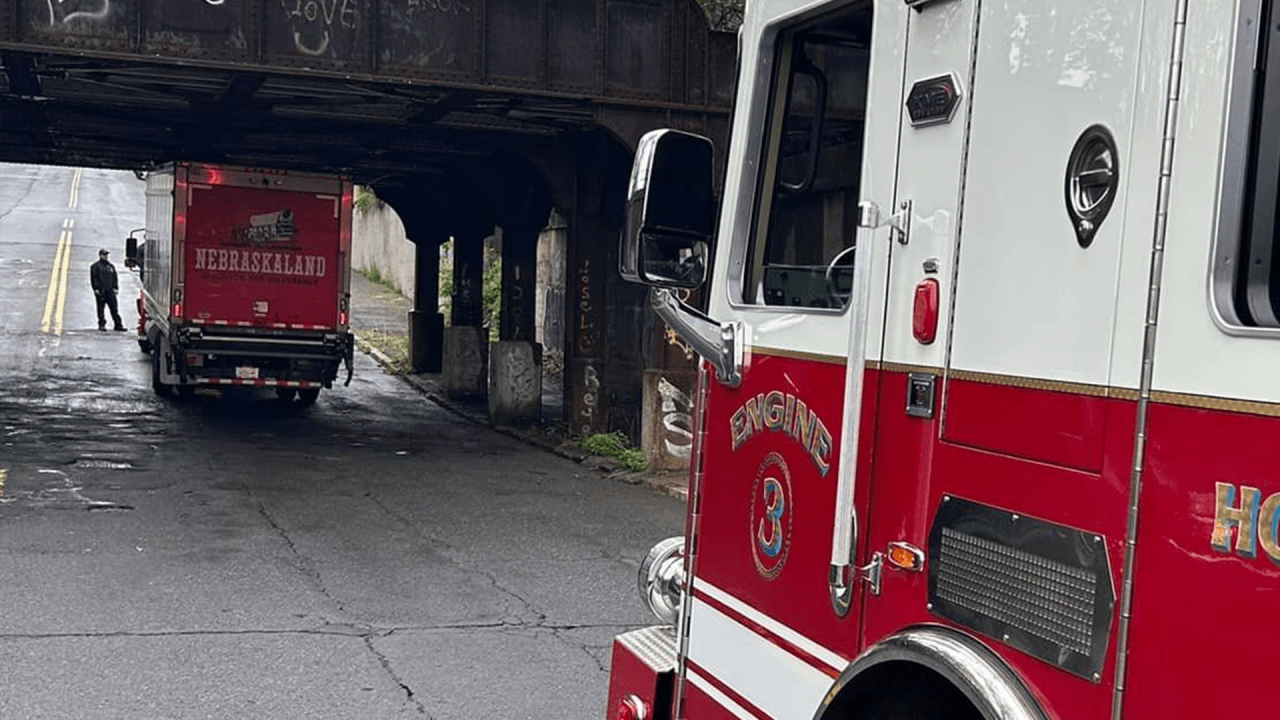 Truck stuck under railroad trestle in Holyoke