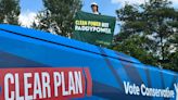 Greenpeace protester mounts Tory bus demanding ‘clean power not Paddy Power’