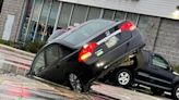 Car swallowed by sinkhole in parking lot outside Town Fair Tire