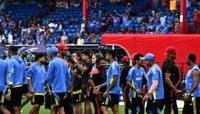 India and Canada team members shake hands after their T20 World Cup group A match was abandoned at Central Broward Stadium