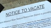 Notice to vacate posted at 84th and Grover encampment one week after flood