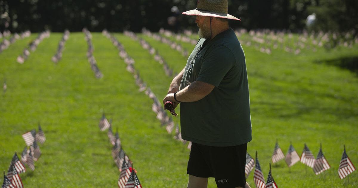 Decorating graves at Quantico, one flag at a time