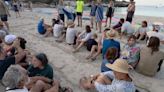 Protesters block beach in Spain spelling out message for tourists in sand