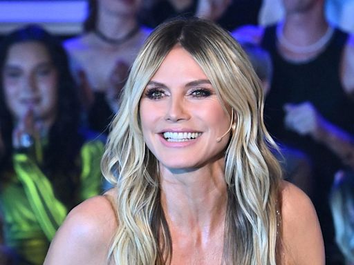 Heidi Klum strikes a pose in bronze metallic swimsuit highlighting her statuesque figure