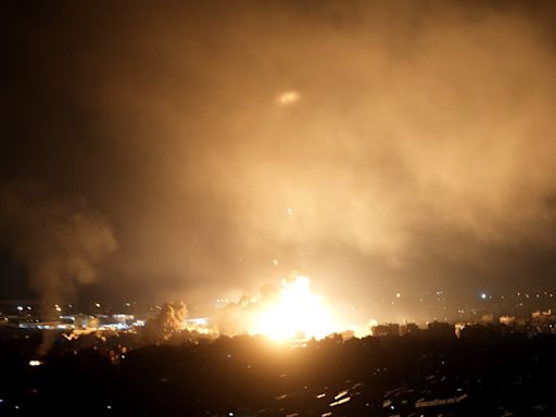 Israeli airstrikes rock southern suburbs of Beirut and cut off a key crossing into Syria