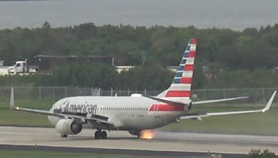 Moment American Airlines Boeing plane's tire explodes during take-off