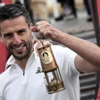 Chief Paris Games organiser Tony Estanguet poses with the Olympic flame in Greece in April