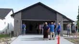Students from Davenport, Bettendorf, show off the house they built