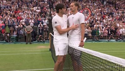 Alexander Zverev holds Taylor Fritz at net after throwing away two-set lead