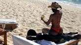 Lori Harvey Sits on Her Boyfriend’s Back and Drinks a Cocktail During Beach Day