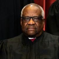 Associate Justice Clarence Thomas sits during a group photo of the Justices at the Supreme Court in Washington, DC in 2021