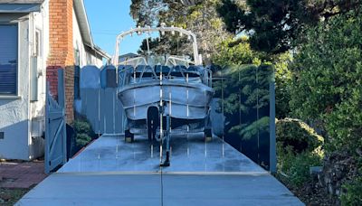 The city made him hide his boat — so he had it painted on his fence