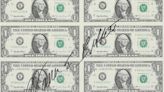 A Warren Buffett autograph across a sheet of uncut dollar bills just sold for $20,740