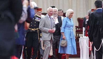 King Charles and Queen Camilla pulled into hotel after aide 'whispers in her ear'