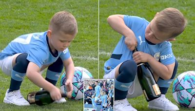 Phil Foden's lad Ronnie, 5, tries to open champagne bottle