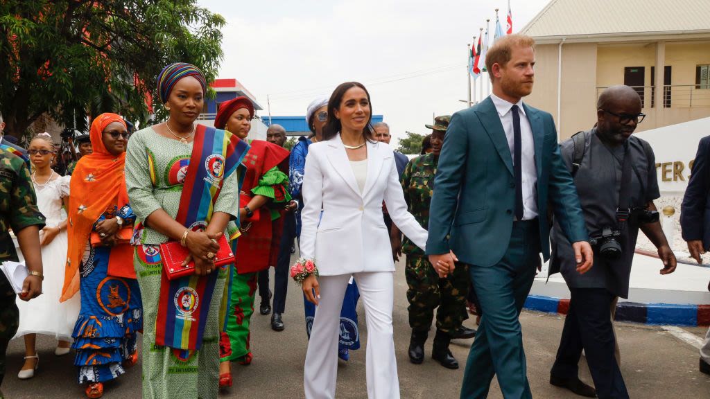 Meghan Changes Into a White Suit With Flared Pants for Second Engagement in Nigeria