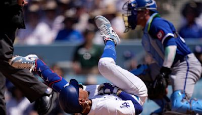 Dodgers star Mookie Betts suffers broken left hand when hit by a pitch