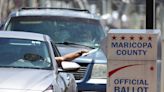 Armed and masked 'ballot watchers' sat by a ballot drop box in Arizona, prompting police investigation