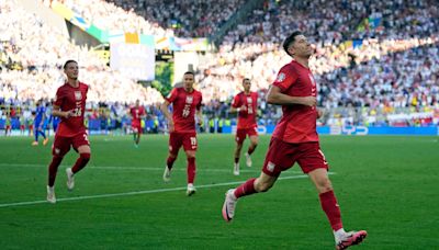 Robert Lewandowski penalty earns Poland a point as France miss out on top spot