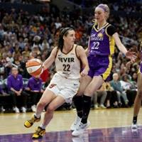 Caitlin Clark of the Indiana Fever drives to the basket against Cameron Brink in the Fever's WNBA victory over the Los Angeles Sparks