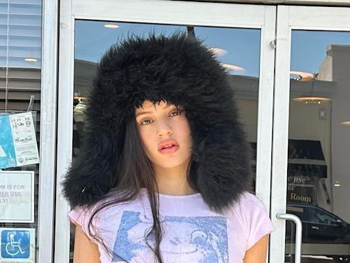 Rosalía Wears a Shearling Trapper Hat to Hilariously Hunt Down Her Dior Billboard