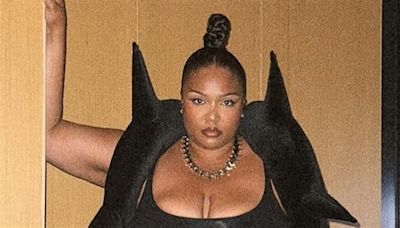 Lizzo showcases her curves and zany sense of style in black crop top with faux fur boots and gothic horned bolero as she says she's 'happier now'